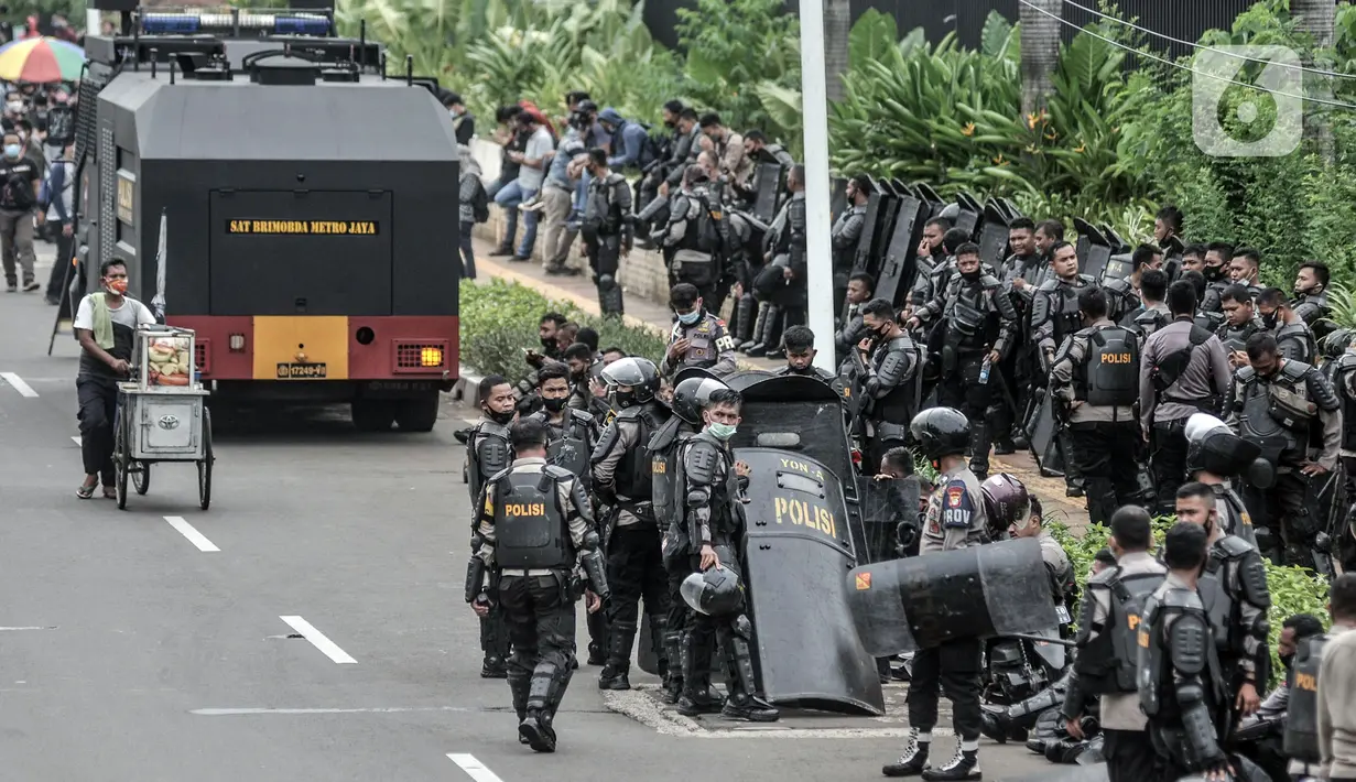 Aparat kepolisian berjaga di sekitar akses menuju Gedung DPR RI guna mengadang massa demonstrasi UU Cipta Kerja, Jakarta, Kamis (8/10/2020). Polri mengerahkan 2.500 personel BKO Brimob Nusantara untuk mengamankan unjuk rasa UU Cipta Kerja di Gedung DPR dan sekitarnya. (merdeka.com/Iqbal S. Nugroho)