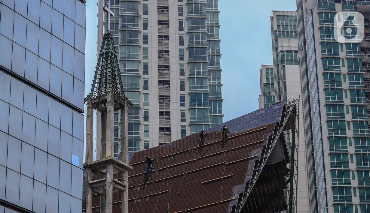 Aktivitas pekerja di atas atap gereja tanpa alat pengaman lengkap, Jakarta, Rabu (12/2/2020). Kemnaker mengatakan tingginya angka kecelakaan kerja di Indonesia disebabkan tidak maksimalnya penerapan K3 yang diatur dalam UU No1 Tahun 1970 tentang Keselamatan Kerja. (Liputan6.com/Faizal Fanani)