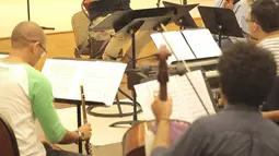 Konduktor Avip Priatna memimpin latihan Jakarta Concert Orchestra (JCO) di Balai Resital Kertanegara, Jakarta, Rabu (28/11). Konser Beat It-A Tribute To Michael Jackson akan dilangsungkan di Taman Ismail Marzuki. (Fimela.com/Bambang Purnama)