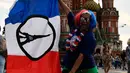 Seoarang fans menbentangkan bendera Prancis di Lapangan Merah di Moskow, Rusia (13/7). Final Piala Piala Dunia 2018 antara Prancis dan Kroasia akan berlangsung di Stadion Luzhniki, Moskow, Rusia. (AFP Photo/Christophe Simon)