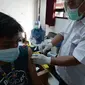 Petugas kesehatan menyuntikkan vaksin COVID-19 kepada warga Kelurahan Gedong di Jakarta, Rabu (23/6/2021). Vaksin bisa mengurangi tingkat keparahan infeksi dan kematian akibat virus, termasuk yang disebabkan varian Delta. (merdeka.com/Imam Buhori)