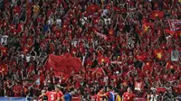Para pemain Timnas Vietnam U-22 melakukan selebrasi bersama pendukung yang hadir langsung di Stadion Rajamangala, Bangkok, Kamis (18/12/2025) usai mereka memastikan diri meraih medali emas sepak bola putra SEA Games 2025. (AFP/Lillian Suwanrampha)