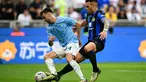 Penyerang Inter Milan #10 Lautaro Martinez berebut bola dengan bek Lazio #34 Mario Gila Fuentes dalam laga giornata 37 Serie A 2023/2024 di Giuseppe Meazza, Minggu (19/5/2024) malam WIB. (Marco BERTORELLO / AFP)