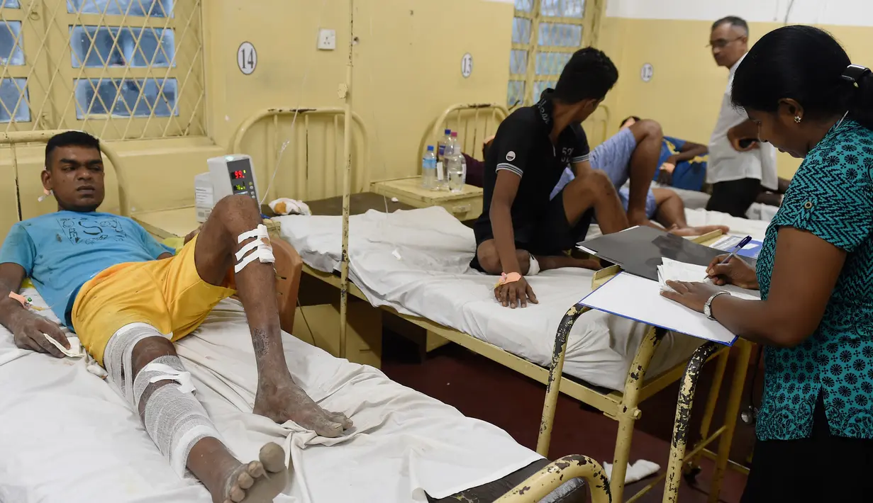 Korban dari bangunan yang roboh mendapat perawatan di Kolombo, Sri Lanka, Kamis (18/5). Sedikitnya 20 pekerja berhasil diselamatkan dan puluhan lainnya masih dalam tahap pencarian. (AFP/Ishara S. KODIKARA)