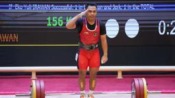 Reaksi atlet Indonesia Eko Yuli Irawan setelah berlaga pada cabang angkat besi 61 kg putra SEA Games 2021 di Hanoi, Vietnam, Jumat (20/5/2022). Total angkatan Eko Yuli Irawan mencapai 290 Kg. (AP Photo/Achmad Ibrahim)