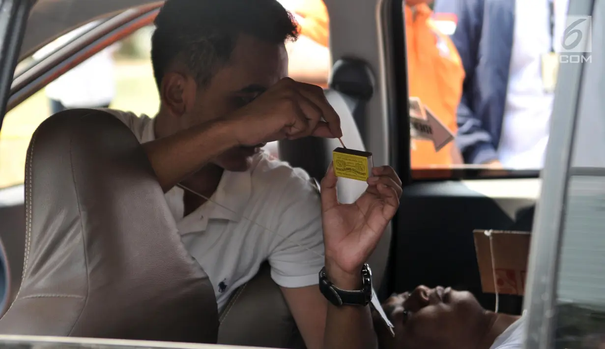 Model yang memerankan tersangka Kelvin memeragakan adegan kasus istri bunuh dan bakar suami serta anak tiri di Polda Metro Jaya, Jakarta, Senin (9/9/2019). Model yang memerankan tersangka Kelvin dan tersangka Aulia Kesuma memeragakan tiga adegan pembakaran korban di mobil. (merdeka.com/IqbalNugroho)