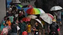 Sejumlah pengojek payung di salah satu tempat perbelanjaan di kawasan Tanah Abang, Jakarta, Selasa (9/2). Pada musim hujan seperti banyak pengojek payung dadakan yang mayoritas adalah anak-anak. (Liputan6.com/Faisal R Syam)