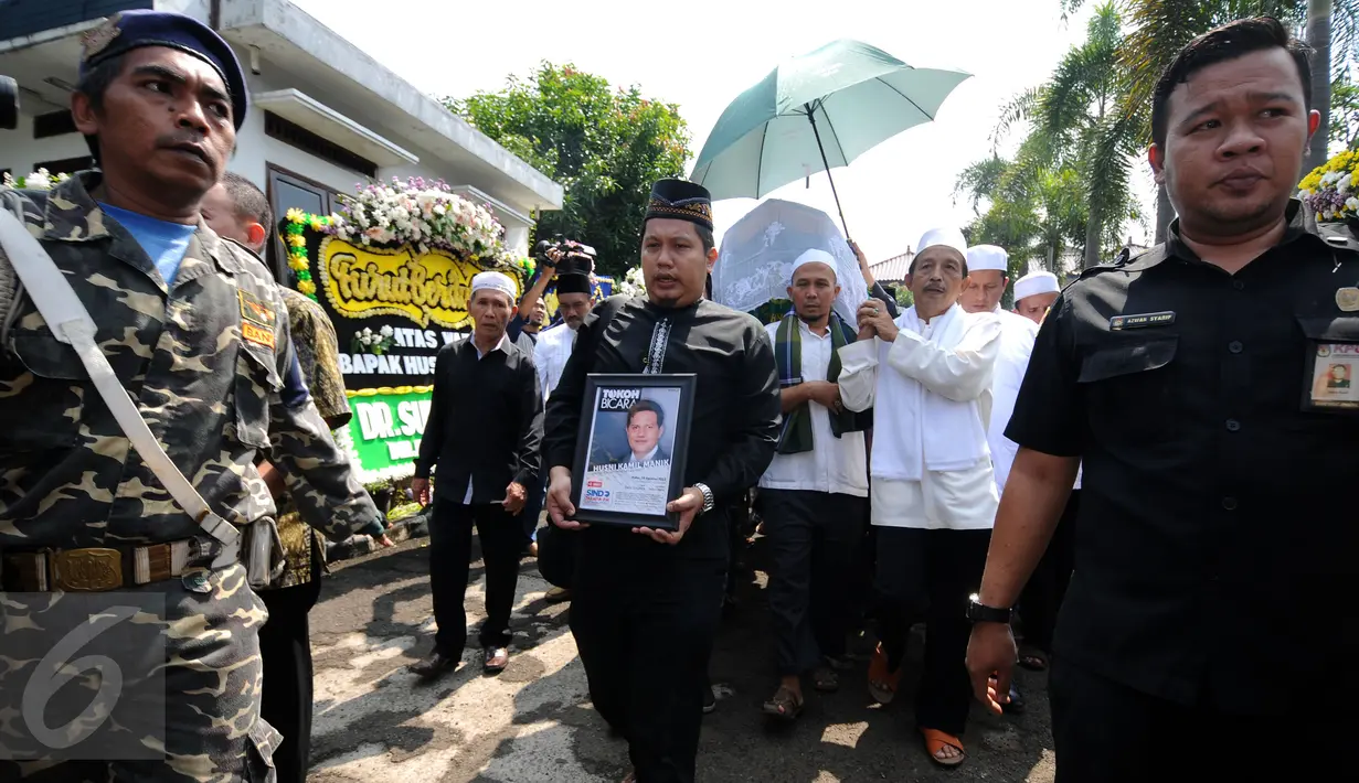 Sejumlah kerabat mengangkat jenazah Ketua KPU Husni Kamil Manik di Kompleks KPU, Jakarta, Jumat (8/7). Husni Kamil Manik wafat di usia 40 tahun pada Kamis malam (7/7). (Liputan6.com/Helmi Fithriansyah)