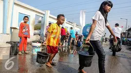 Sejumlah anak membawa ember yang berisi air bersih di kawasan Muara Angke, Jakarta, Selasa (4/8/2015). Memasuki musim kemarau, warga kesulitan mendapatkan air bersih karena beberapa sumber air mengalami kekeringan. (Liputan6.com/Faizal Fanani)