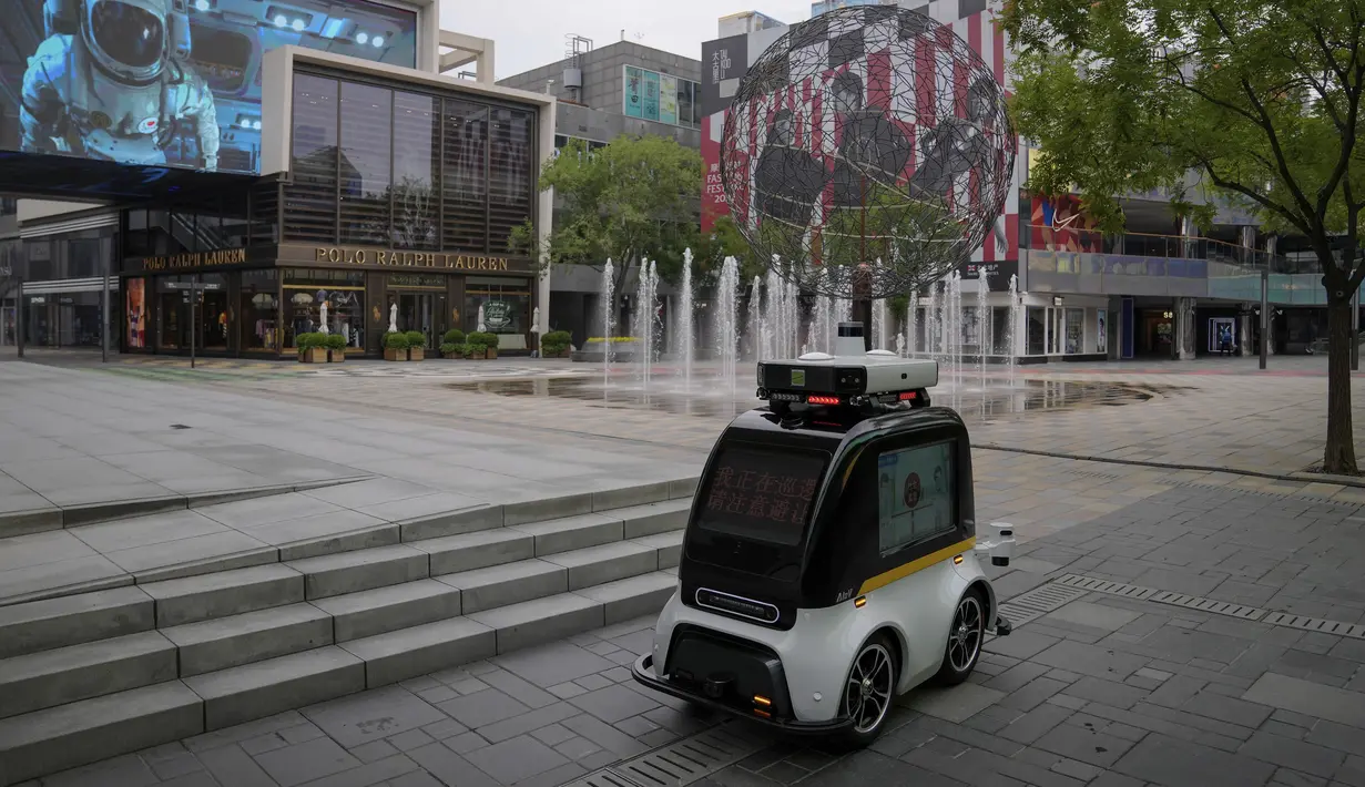 <p>Robot otonom melintasi pusat perbelanjaan yang sepi saat sebagian besar toko diperintahkan tutup sebagai bagian dari pengendalian COVID-19 di Beijing, Senin (13/6/2022). Pengujian massal akan berlangsung antara Senin hingga Rabu di distrik Chaoyang, tempat bar itu berada, menurut para pejabat dalam konferensi pers. (AP Photo/Andy Wong)</p>