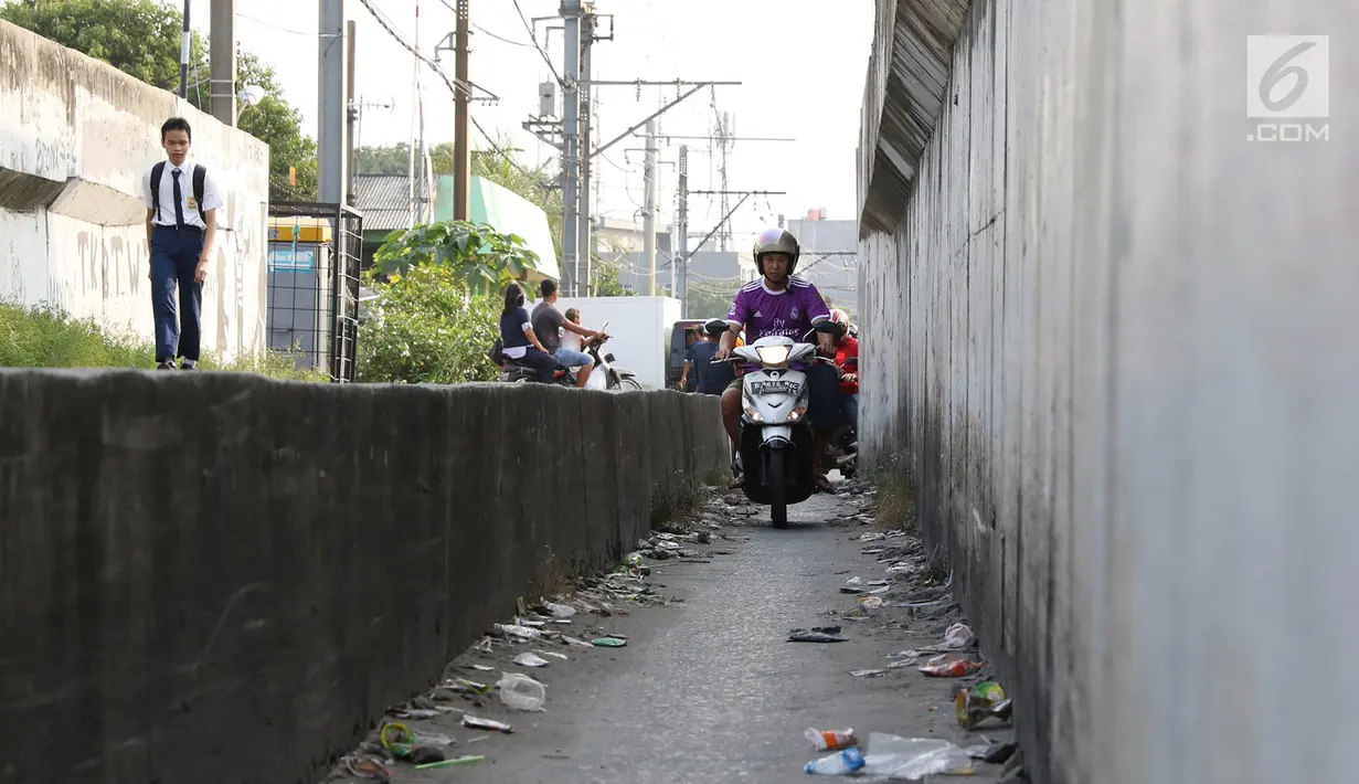 Suasana  jalan setapak di pinggir rel kereta di kawasan Tambora, Jakarta, Senin (10/7). Tidak tersedianya akses jalan untuk putar balik membuat warga terpaksa memanfaatkan jalan setapak tersebut. (Liputan6.com/Immanuel Antonius)