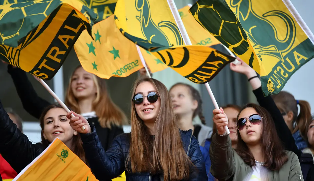 Para suporter wanita dari Australia mengibarkan bendera saat berada di Kazan, Senin (11/6/2018). Jelang Piala Dunia, para suporter mulai berdatangan ke Rusia. (AFP/Saeed Khan)