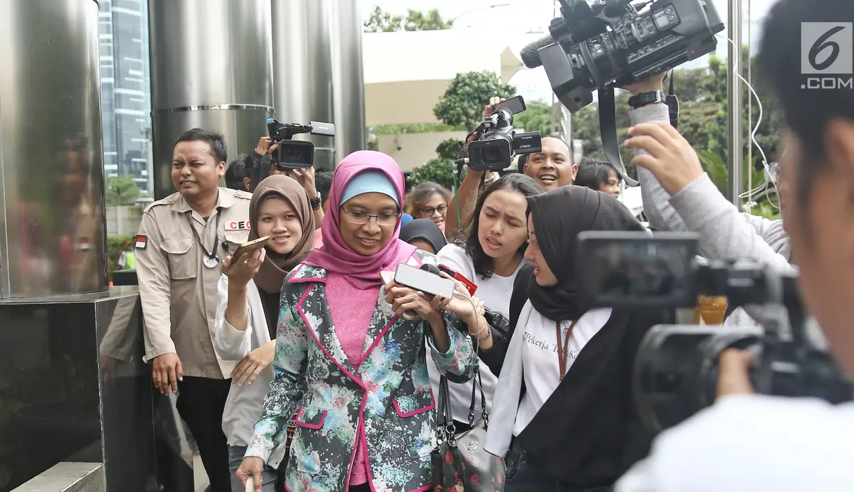 Direktur Produksi PT Garuda Indonesia Puji Nur Handayani menghindari awak media seusai pemeriksaan di Gedung KPK, Rabu (21/3). Selain Puji, tim penyidik juga memanggil pensiunan pegawai Garuda Indonesia Capt Agus Wahjudo. (Liputan6.com/Herman Zakharia)