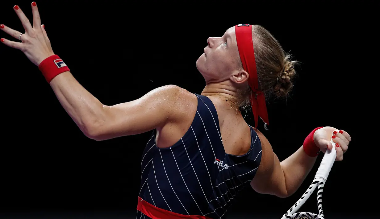 Petenis Belanda, Kiki Bertens bersiap melakukan servis ke arah petenis Australia, Ashleigh Barty pada turnamen WTA Finals 2019 di Shenzhen, China, Selasa (29/10/2019). Bertens secara mengejutkan mengalahkan petenis peringkat satu dunia dengan 3-6, 6-3, 6-4 dalam waktu 2 jam 9 menit. (AP/Andy Wong)