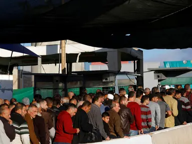 Sejumlah warga Palestina bersiap melaksanakan salat Jumat pertama Ramadan di masjid al-Aqsa Yerusalem, di pos pemeriksaan Qalandia, di Tepi Barat yang diduduki Israel (10/5/2019). (Reuters/Mohamad Torokman)