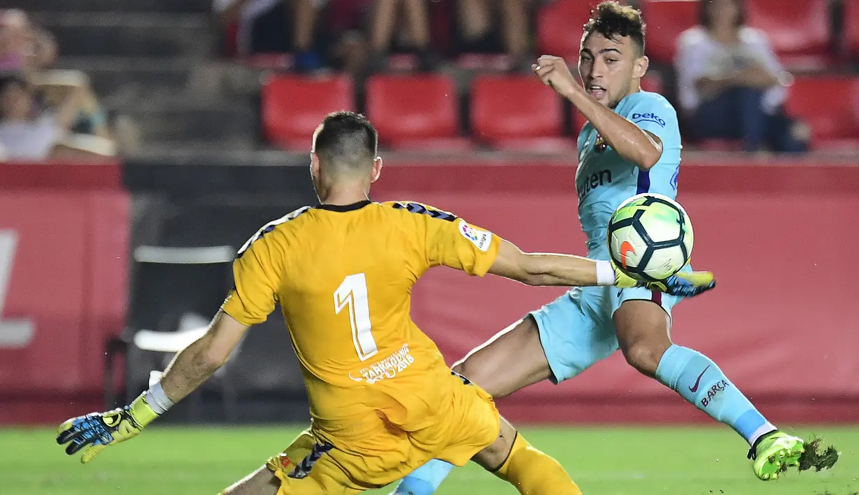 Kiper Gimnastic, Dimitrievski (kiri) menghadang tembakan pemain Barcelona, Munir El Haddadi pada laga persahabatan di Nou Estadi, Tarragona, (4/8/2017). (AFP/Jose Jordan)