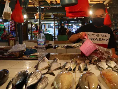 Pedagang menyirami ikan jualannya agar kelihatan segar di Pasar Senen, Jakarta, Jumat (8/1/2021). Harga jual ikan laut saat ini mengalami lonjakan yang diakibatkan kurangnya pasokan ikan dari nelayan ke pedagang di pasar tradisional. (merdeka.com/Imam Buhori)