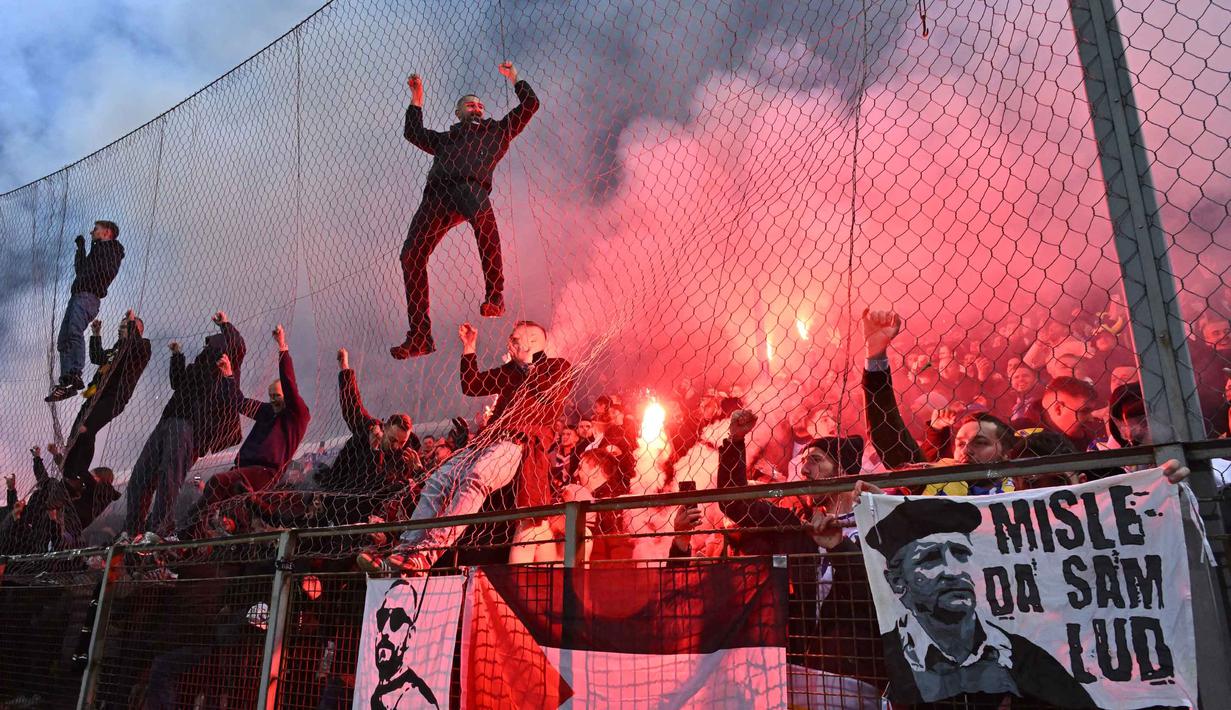Suporter Timnas Bosnia dan Herzegovina merayakan kemenangan atas Italia pada final play-off kualifikasi Piala Dunia 2026 zona Eropa melawan Italia di Stadion Bilino Polje, Zenica, Selasa 31 Maret 2026 waktu setempat atau Rabu 1 April 2026 dini hari WIB. Bosnia dan Herzegovina memastikan tiket berlaga di ajang Piala Dunia 2026. (Elvis BARUKCIC/AFP)