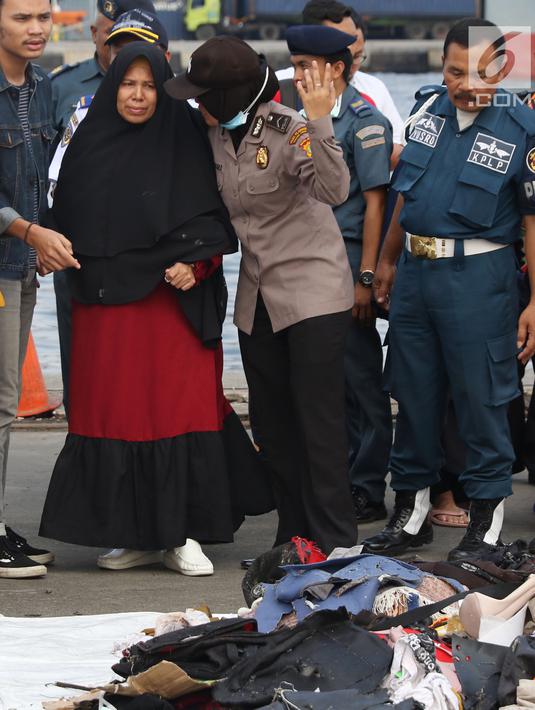 Keluarga korban jatuhnya pesawat Lion Air JT 610 dikawal petugas melihat barang-barang temuan di Pelabuhan JICT 2, Jakarta, Rabu (31/10). 189 orang menjadi korban jatuhnya pesawat Lion Air JT-610 pada Senin (29/10) lalu. (Liputan6.com/Helmi Fithriansyah)