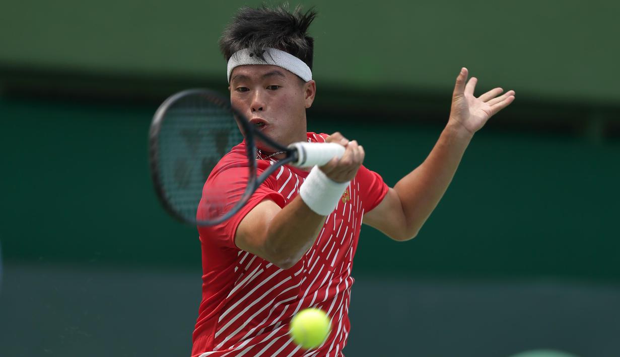 Petenis Indonesia, David A. Santoso, berusaha mengembalikan bola saat melawan petenis Selandia Baru, Rhett Purcell, pada laga Piala Davis 2019 Grup II Zona Asia/Oceania di Stadion Tenis GBK, Jakarta, Sabtu (14/9). David kalah  6-3, 4-6, 0-6 dari Rhett. (Bola.com/Peksi Cahyo)