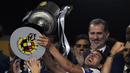 Kapten Valencia, Daniel Parejo, mengangkat trofi Copa del Rey usai mengalahkan Barcelona pada laga Copa del Rey di Stadion Benito Villamarin, Sevilla, Sabtu (25/5). Barcelona kalah 1-2 dari Valencia. (AFP/Pau Barrena)