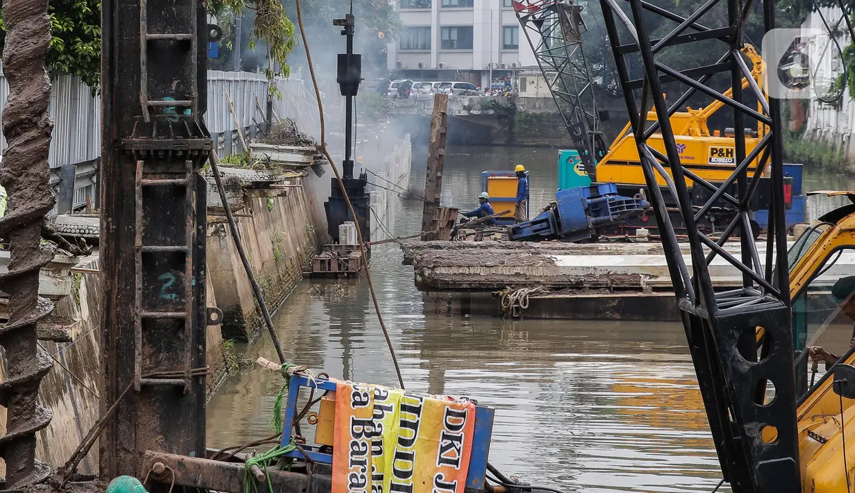 Pekerja menyelesaikan pemasangan dinding turap di kali pasar baru, Jakarta, Rabu (9/3/2022). Dinas Sumber Daya Air DKI Jakarta melakukan pemasangan turap bertujuan untuk mengantisipasi banjir serta tanah ambles di pinggir sungai. (Liputan6.com/Faizal Fanani)