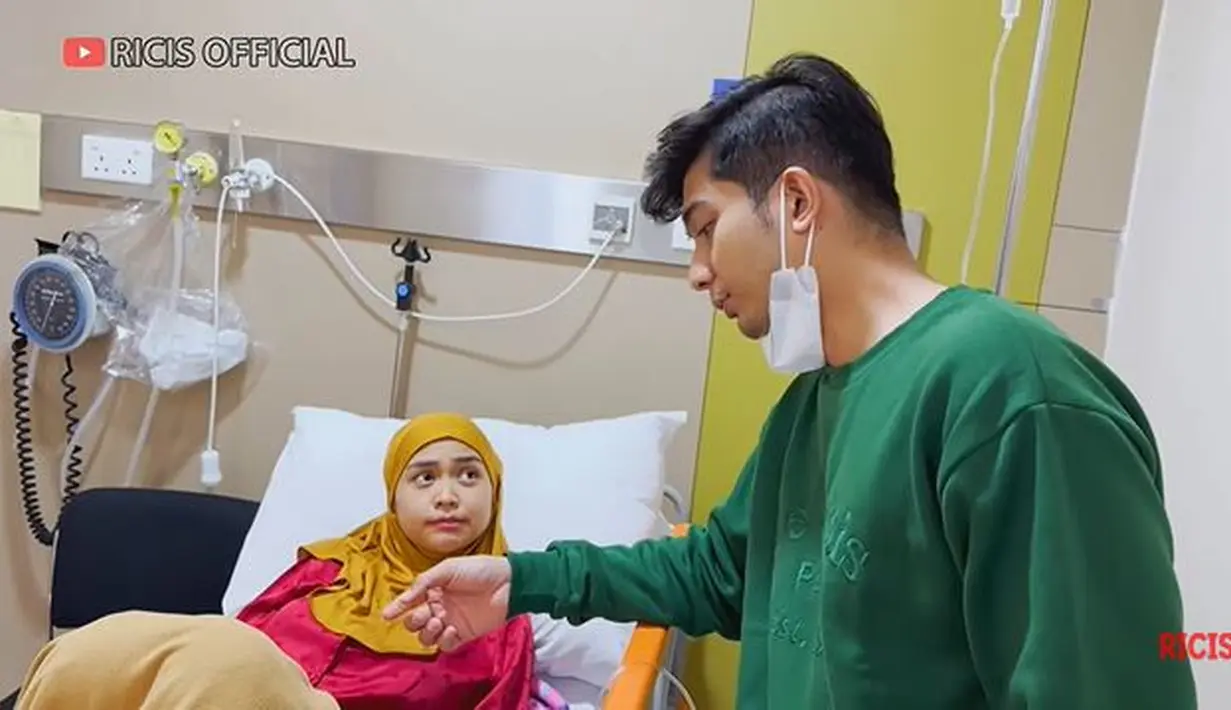Perawatan dari dokter membuat Ricis terlihat semakin membaik. Raut wajahnya pun sudah tampak lebih cerah. Selama sakit, Teuku Ryan tampak selalu menemani sang istri. Ia juga memberikan perhatian lebih pada Ricis. Sebelum dilarikan ke rumah sakit, ibu satu anak itu mengatakan tubuhnya demam yang disertai haid.  (Liputan6.com/YouTube/Ricis Official)