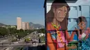 Mural berjudul 'Contos' yang dilukis Luna Buschinelli (19), di dinding gedung sekolah Rio de Janeiro, Brasil, (19/6). Karya berukuran 2.500 meter persegi itu memecahkan rekor dunia sebagai mural terbesar yang dibuat oleh wanita. (AP/Silvia Izquierdo)