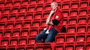 Seorang pendukung terlihat di tribun usai pertandingan antara Liverpool dan Wolverhampton Wanderers pada lanjutan Liga Inggris di stadion Anfield (12/5/2019). Meskipun menang 2-0, Liverpool gagal meraih juara Liga Inggris karena Manchester City mengalahkan Brighton 4-1. (AP Photo/Dave Thompson)