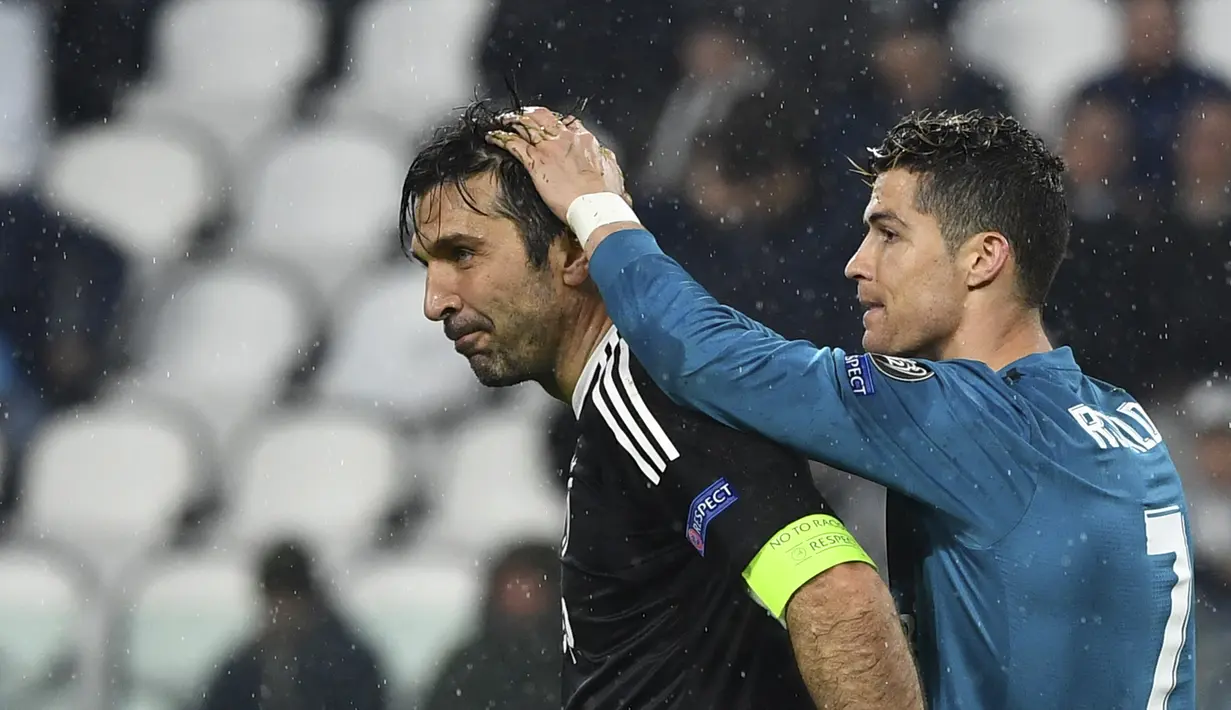 Pemain Real Madrid, Cristiano Ronaldo (kanan) memegang kepala kiper Juventus, Gianluigi Buffon usai laga  leg pertama Liga Champions di Allianz Stadium, Turin, (3/4/2018). Ronaldo mencetak dua gol ke gawang Juventus. (AFP/Alberto Pizzoli)
