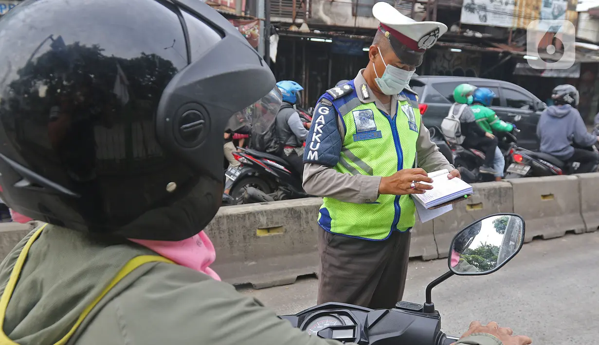 Polisi menilang pengendara sepeda motor yang menerobos jalur Transjakarta di Jalan Sultan Agung, Manggarai, Jakarta, Rabu (12/2/2020). Pengendara kerap melintasi jalur Transjakarta untuk menghindari kemacetan lalu lintas. (Liputan6.com/Herman Zakharia)