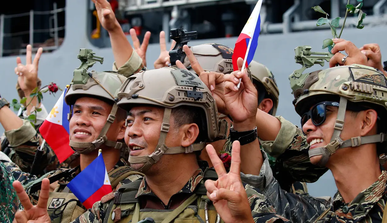 Tentara Filipina yang bertempur di kota Marawi foto bersama usai turun dari kapal amfibi Angkatan Laut Filipina BRP Tarlac di Manila, Filipina (30/10). Kota Marawi berhasil direbut dari para militan. (AP Photo / Bullit Marquez)