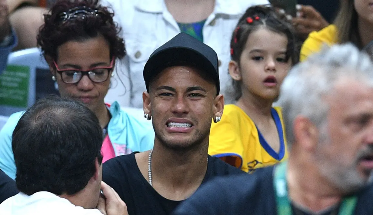 Salah satu ekspresi Neymar saat menyaksikan  tim bola voli Brasil berhasil meraih medali emas pada laga final bola voli putra  Olimpiade Rio 2016 melawan Italia di Stadion Maracanazinho, Rio de Janeiro, (21/8/2016). (AFP/Johannes Eisele)