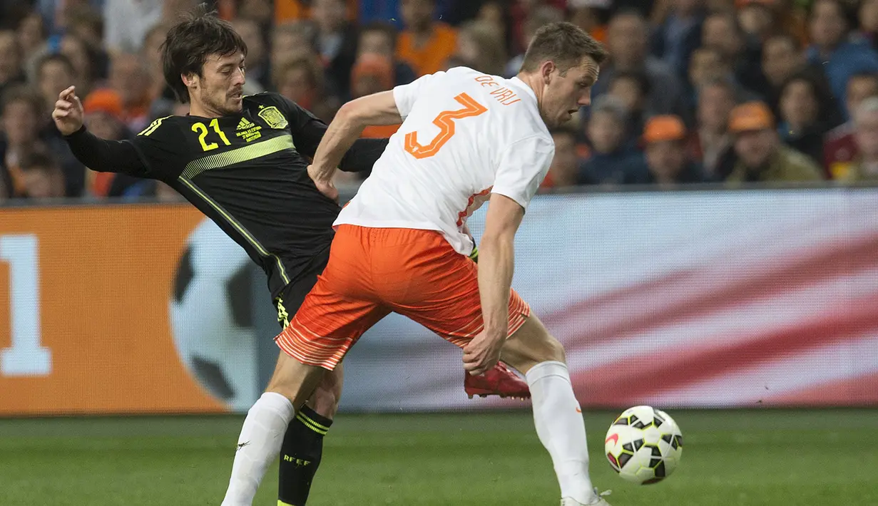 Gelandang Spanyol, David Silva (kiri) berusaha melewati pemain bek Belanda Stefan de Vrij pada laga persahabatan di Amsterdam Arena, Belanda, Rabu (1/4/2015). Belanda menang 2-0 atas Spanyol. (REUTERS/Toussaint Kluiters)