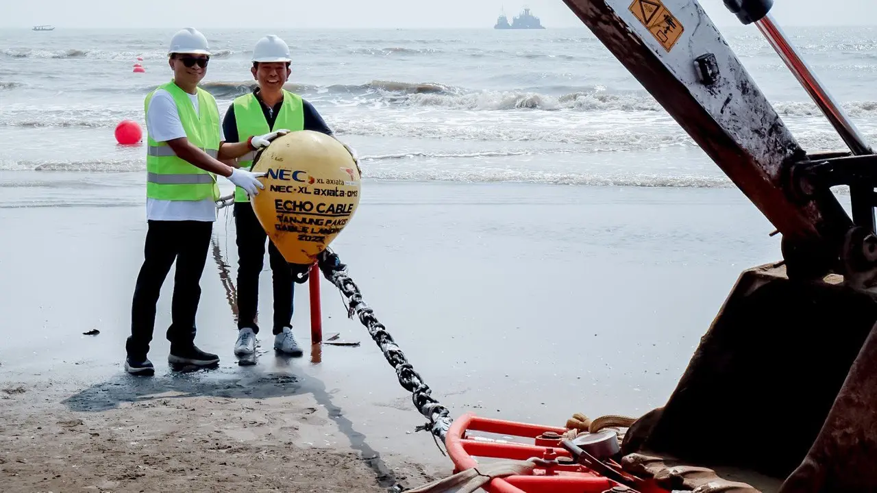 Direktur Teknologi XL Axiata I Gede Darmayusa (kiri) dan SVP PT NEC Indonesia Dolat Sembiring menarik kabel laut Echo di Tanjung Pakis, Karawang, Jawa Barat.