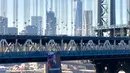 Banner ukuran 6x9 meter bergambar Presiden Rusia Vladimir Putin tergantung di Jembatan Manhattan, New York, Kamis (6/10). Pada banner itu terlihat gambar Putin yang menggunakan jas di depan bendera Rusia. (Kathryn Peters/Handout via Reuters)