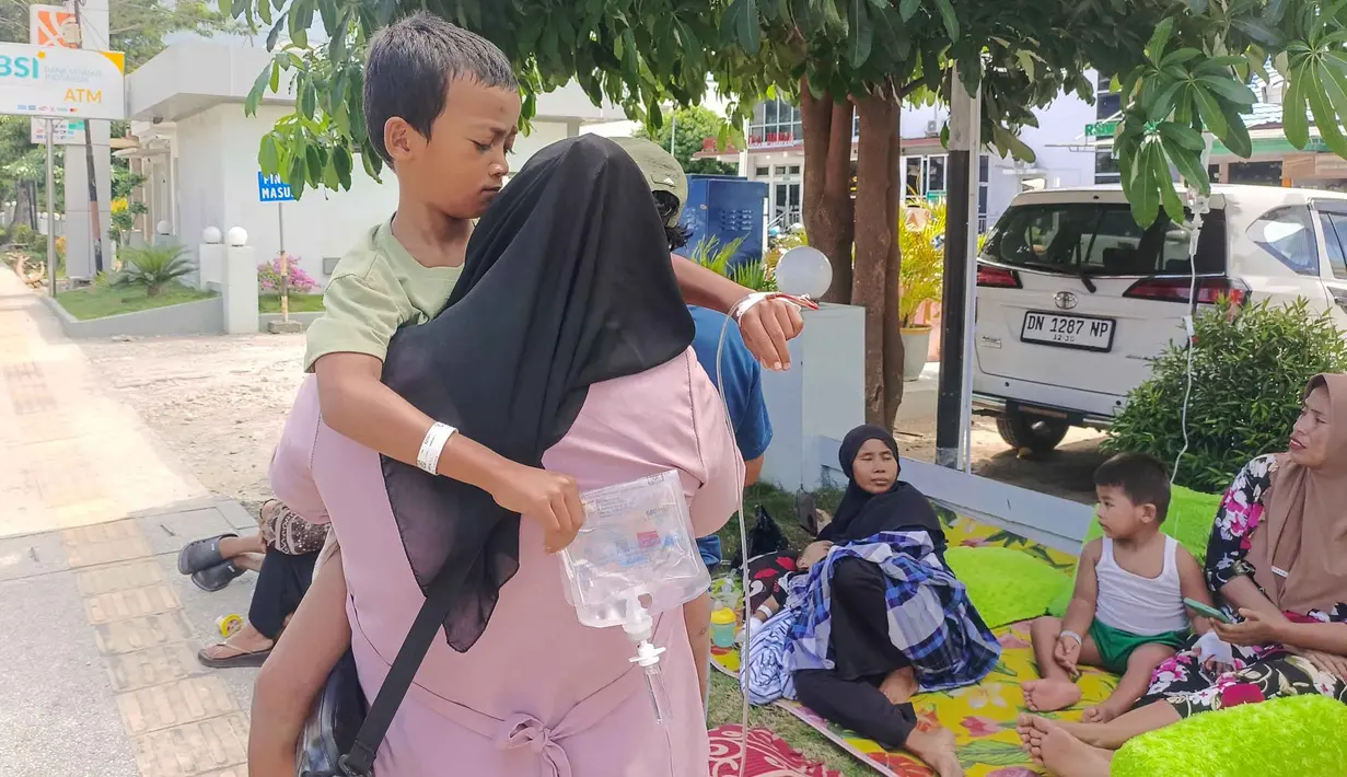 Pasien dan personil keluarganya mengungsi di luar Rumah Sakit Umum Anutapura menyusul gempa berkekuatan magnitudo 6,7 di Palu, Sulawesi Tengah, Selasa 16 Juni 2026. (MUHAMMAD RIFKI/AFP)
