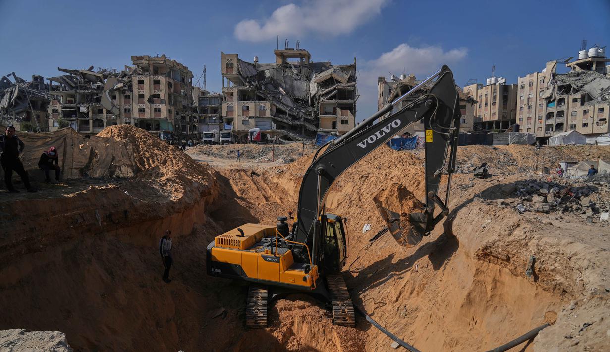 Aktivitas pekerja Mesir yang menggunakan alat berat untuk mencari jenazah para sandera di Kota Hamad, Khan Younis, di Jalur Gaza selatan, Selasa 28 Oktober 2025. Selain di Khan Younis, pencarian juga dilakukan di sejumlah lokasi, termasuk kamp pengungsi Nuseirat. (AP Photo/Abdel Kareem Hana)