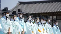 Pria mengenakan pakaian tradisional Korea Selatan menghadiri upacara untuk menghidupkan kembali Hari Kedewasaan ke-50 di Desa Namsangol Hanok di Seoul, Korea Selatan (16/5/2022). Upacara diadakan untuk pria dan wanita muda yang akan berusia 20 tahun. (AP Photo/Lee Jin-man)