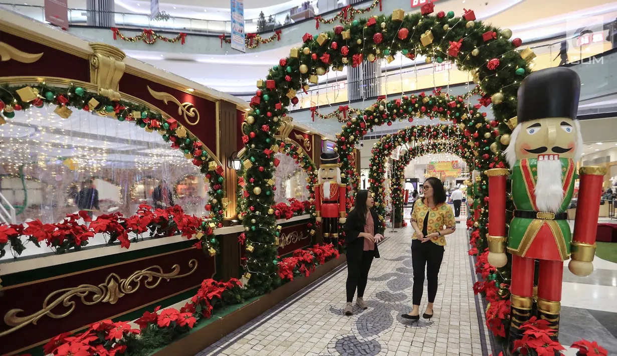 Pengunjung melintasi lorong berdekorasi natal di atrium Lippo Mall Puri, Jakarta, Kamis (29/11). Kegiatan Holiday Sensation diselenggarakan di 68 mal di berbagai kota. (Liputan6.com/Fery Pradolo)