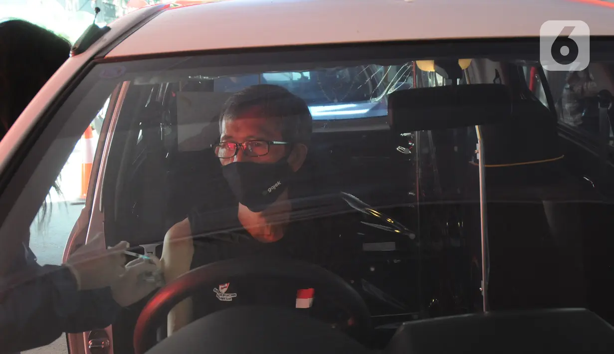 Paramedis menyuntikkan vaksin COVID-19 secara drive thru kepada pengendara mobil di GOR Pajajaran, Kota Bogor, Jawa Barat, Rabu (17/3/2021). Kegiatan ini diselenggarakan oleh Halodoc, Gojek, dan Pemkot Bogor. (merdeka.com/Arie Basuki)