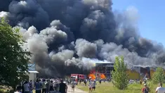 Orang-orang menyaksikan asap mengepul setelah serangan roket Rusia menghantam pusat perbelanjaan yang ramai, di Kremenchuk, Ukraina (27/6/2022). Pejabat Ukraina mengatakan sejumlah warga sipil dikhawatirkan tewas atau terluka setelah serangan rudal Rusia menghantam pusat perbelanjaan yang ramai di pusat kota Kremenchuk. (Viacheslav Priadko via AP)