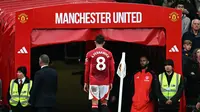 Gelandang Manchester United (MU), Bruno Fernandes, meninggalkan lapangan karena kartu merah yang diterimanya saat menghadapi Tottenham Hotspur di Old Trafford, Minggu (29/9/2024). (Paul ELLIS / AFP)