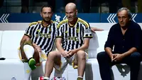 Mantan pemain Juventus (dari kiri) Mark Juliano, Zinedine Zidane dan Michel Platini duduk di bangku cadangan Tim Putih dalam laga persabatan mini soccer 7 lawan 7 di Pala Alpitour, Turin, Rabu (11/10/2023) dini hari WIB yang diikuti para legenda Juventus dalam rangkaian perayaan 100 tahun Keluarga Agnelli mengakuisisi Juventus. Hasil laga dimenangkan Tim Putih 9-6 atas Tim Hitam. (AFP/Marco Bertorello)