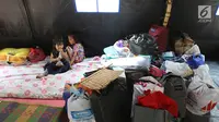 Anak-anak beristirahat di posko pengungsian SDN 10/11 Pagi Cipinang Utara, Jakarta, Selasa (20/8/2019). Puluhan warga terdampak kebakaran di Kawasan Prumpung, Jatinegara saat ini masih sangat membutuhkan bantuan seperti alas tidur dan popok bayi. (Liputan6.com/Herman Zakharia)