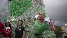 Anak-anak muda berpakaian karakter Natal berpose untuk foto sebelum upacara penyalaan pohon Natal yang terbuat dari botol plastik daur ulang di Caracas, Venezuela, Selasa (13/12/2022). Pohon Natal yang dibuat dari sekitar 15.000 botol plastik daur ulang ini diinisiasi oleh organisasi nirlaba dan non-pemerintah Oko Spire dan kolaborator. (Yuri CORTEZ / AFP)