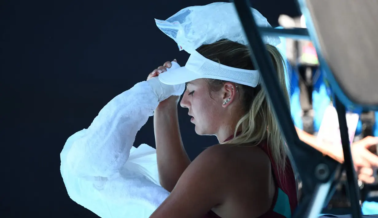 Petenis Ukraina Marta Kostyuk meletakkan es di kepalanya untuk mendinginkan diri saat bermain melawan petenis Spanyol Paula Badosa pada pertandingan tunggal putri turnamen tenis Australian Open di Melbourne, Australia, 21 Januari 2022. (William WEST/AFP)