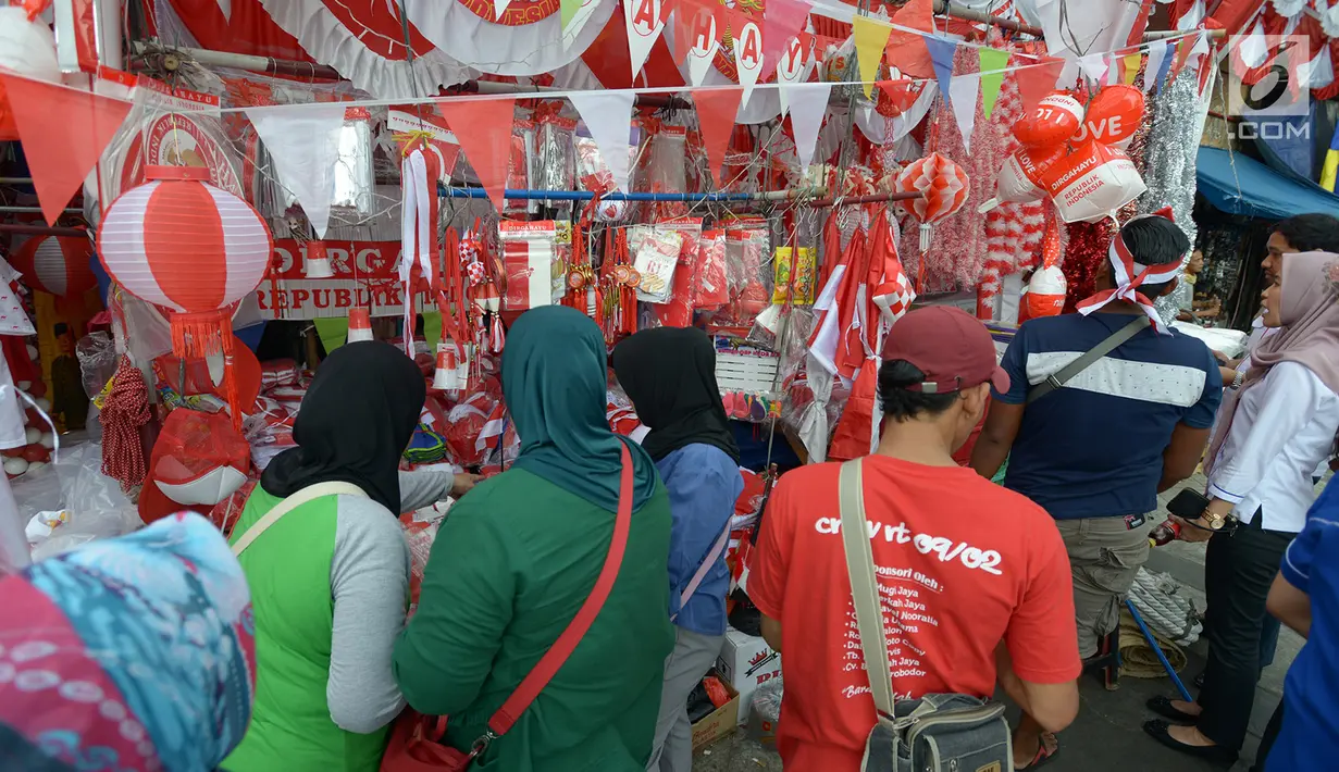Pembeli melihat-lihat bendera Merah Putih dan pernak-pernik Hari Kemerdekaan di kawasan Pasar Jatinegara, Jakarta, Rabu (14/8/2019). Pedagang musiman memajang beragam jenis aksesoris seperti bendera merah putih, umbul-umbul dan lambang Garuda untuk perayaan HUT ke-74 RI. (merdeka.com/imam buhori)