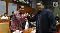 Menteri Pendidikan dan Kebudayaan Nadiem Makarim (kiri) bersalaman dengan Wakil Komisi X DPR Dede Yusuf saat rapat dengan Komisi X DPR di Kompleks Parlemen, Senayan, Jakarta, Kamis (12/12/2019). Rapat membahas penghapusan Ujian Nasional (UN) pada 2021 dan sistem zonasi. (Liputan6.com/Johan Tallo)