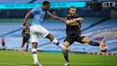 Pemain Manchester City Raheem Sterling (kiri) mencetak gol ke gawang Arsenal pada laga Premier League di Etihad Stadium, Manchester, Inggris, Rabu (17/6/2020). Manchester City menang dengan skor 3-0. (Dave Thompson/POOL/AFP)